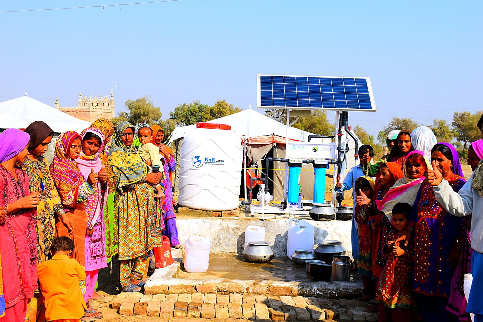 A community gathered at the solar filtration plant that now serves them