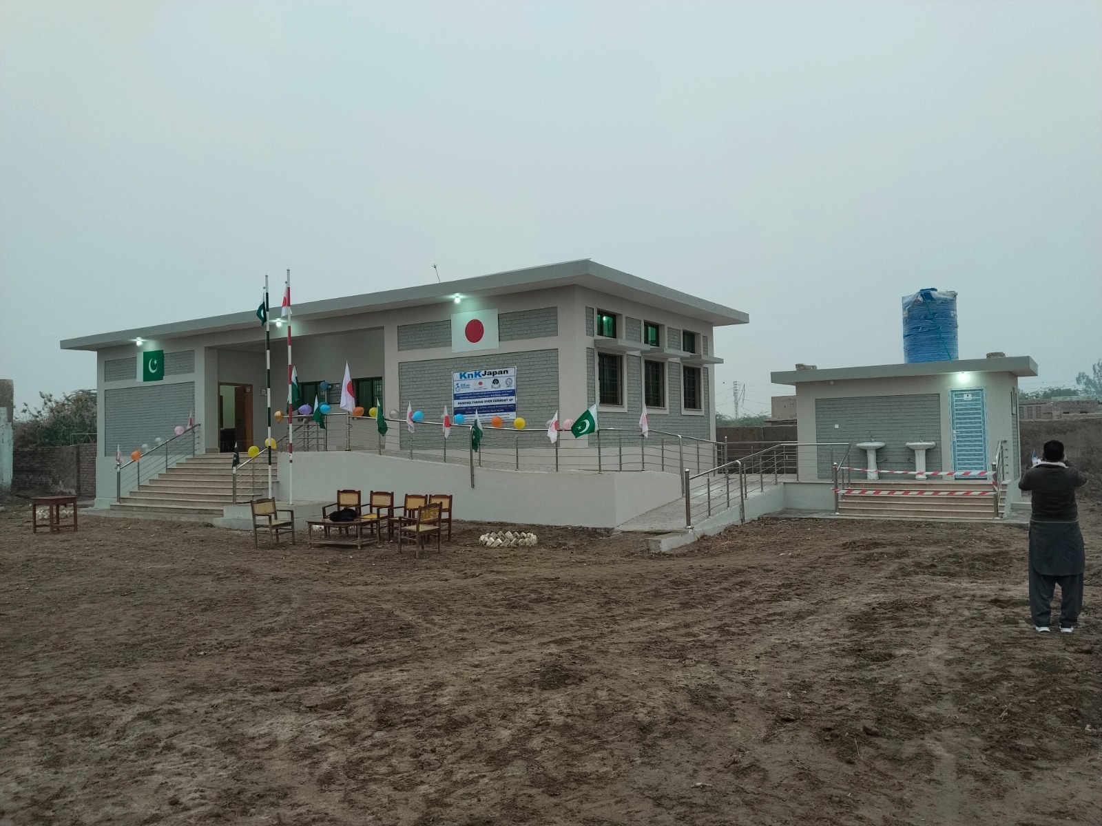 Handover — Dusk handover ceremony · BHU complete and ready for service.